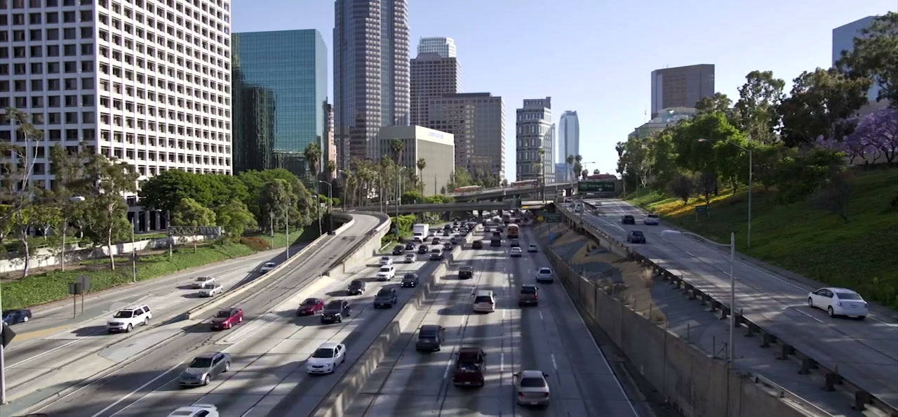 BYD electric buses on a Los Angeles freeway overpass