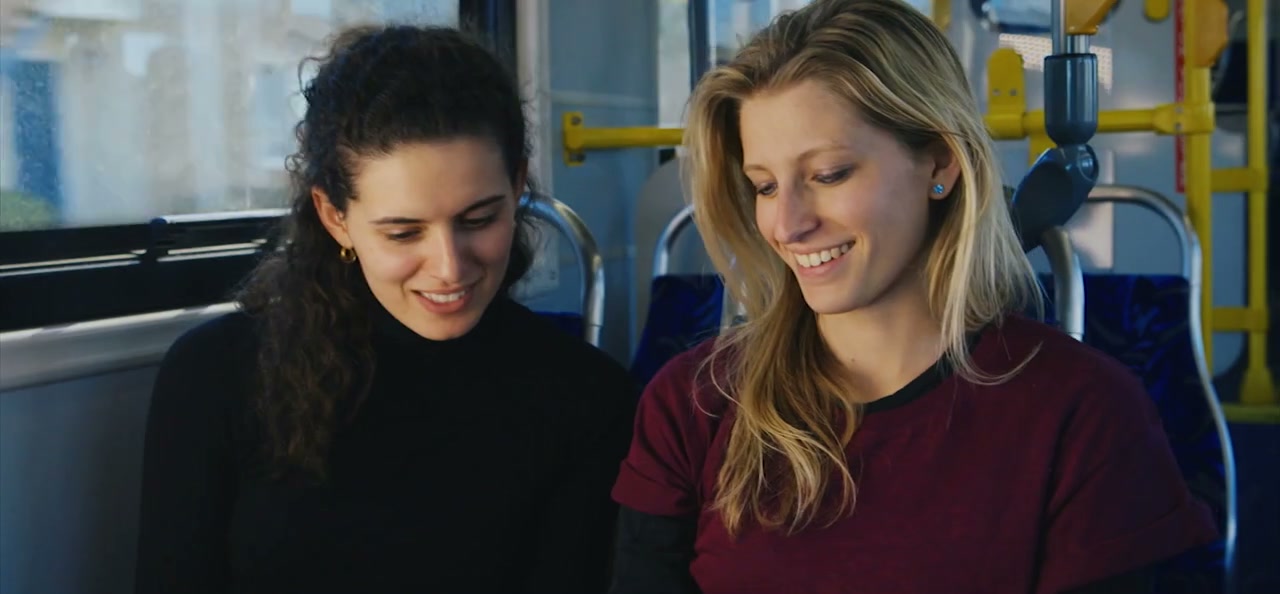 Passengers smiling aboard a BYD electric bus